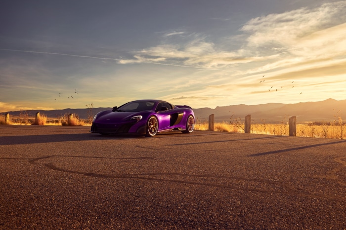 Purple McLaren 675LT sports car on asphalt road