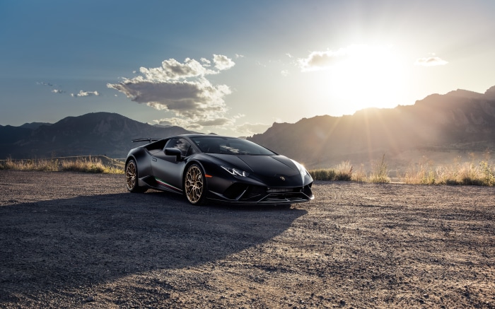 Black Lamborghini Huracan on a dirt road