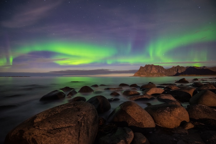 Aurora Borealis over rocky beach 4K