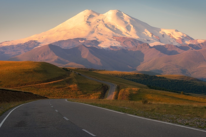 Road leading to Mount Elbrus at sunset