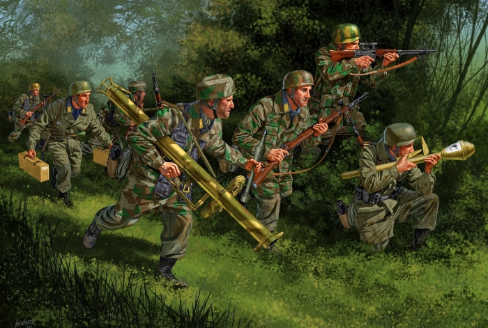 German soldiers advancing in a forest with weapons