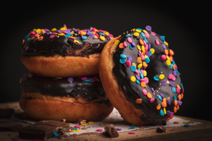 Chocolate donuts with colorful sprinkles 4K