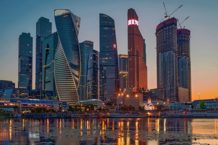 Moscow City skyscrapers at dusk with river reflection