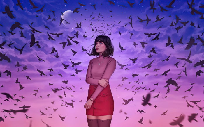 Woman surrounded by a flock of birds at sunset