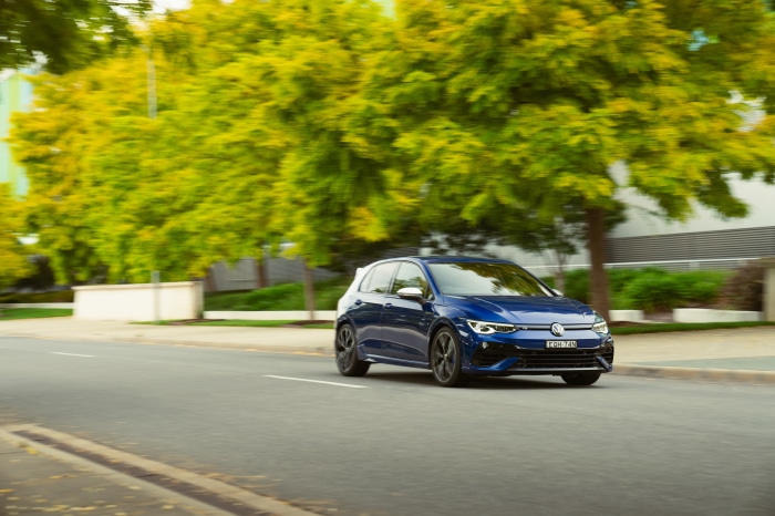 Blue Volkswagen Golf R driving on a street