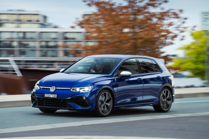 Blue Volkswagen Golf R driving on a road