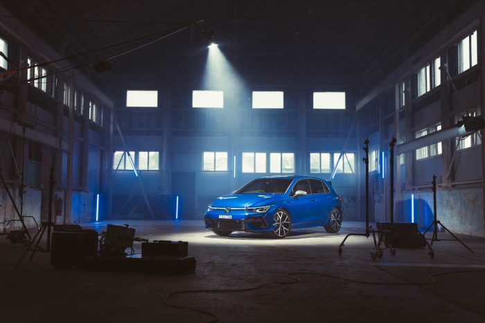 Blue Volkswagen Golf R in a studio with lighting