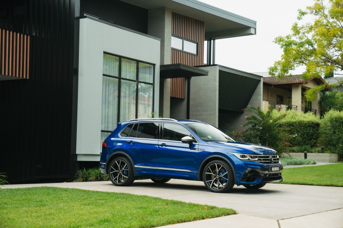 Blue Volkswagen Tiguan R 4K parked in front of a modern house