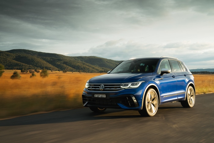 Blue Volkswagen Tiguan R driving on a road