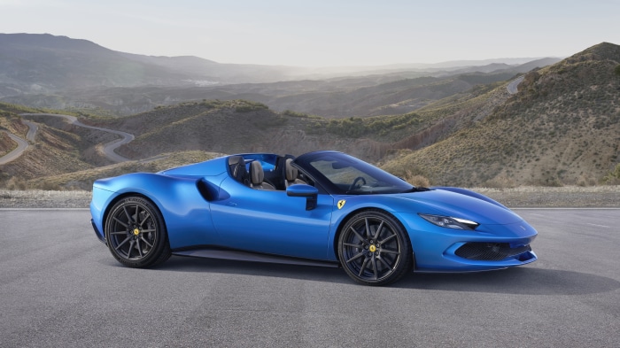 Blue Ferrari 296 GTS convertible on a winding road