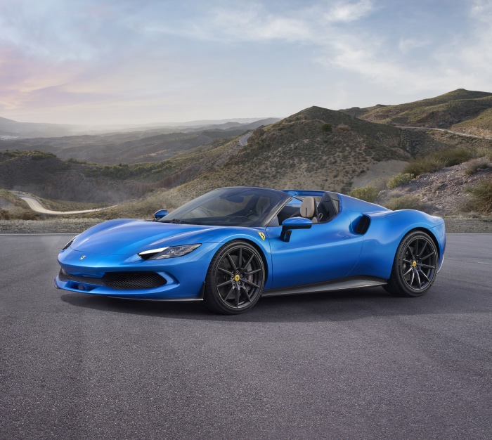 Blue Ferrari 296 GTS convertible on a mountain road