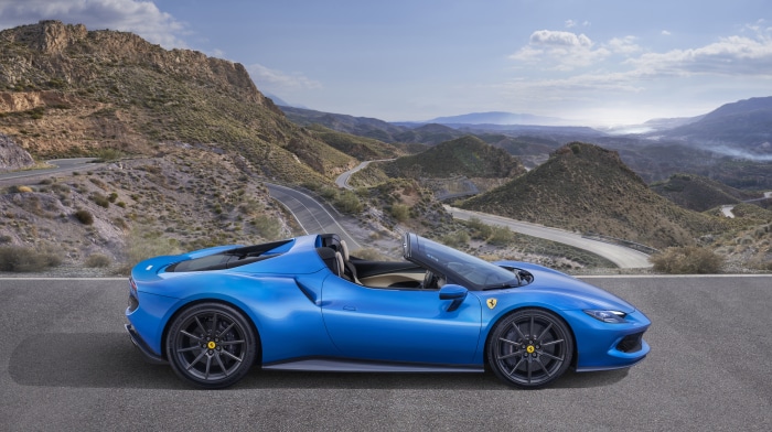 Blue Ferrari 296 GTS convertible on a mountain road