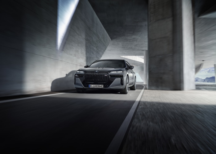 BMW 760i xDrive driving under concrete overpass