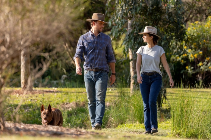 Adam Demos and Victoria Justice walking with a dog