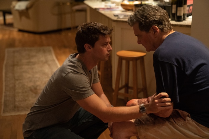 Colin Firth and young man in room
