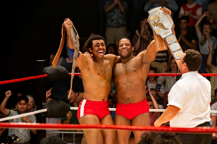 Wrestlers celebrating with championship belts