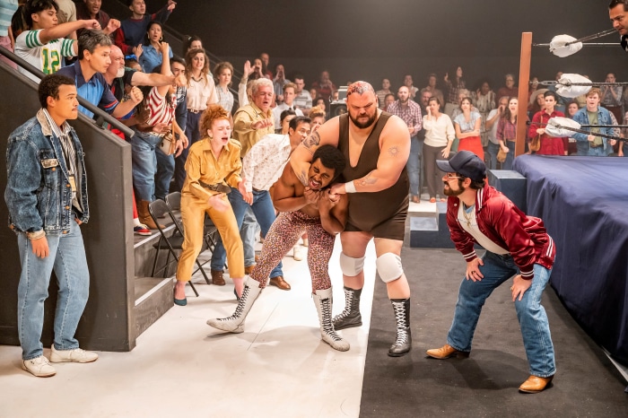 Wrestlers in a ring with spectators