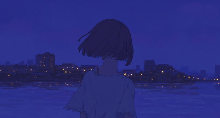 Girl looking at city lights at night