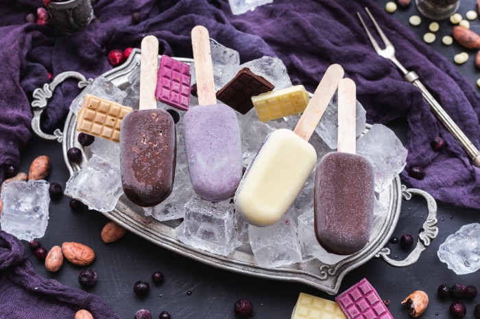 Assortment of Ice Cream Bars on a Tray with Berries and Chocolate