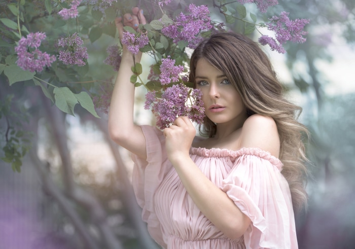 Woman in pink dress with lilac flowers