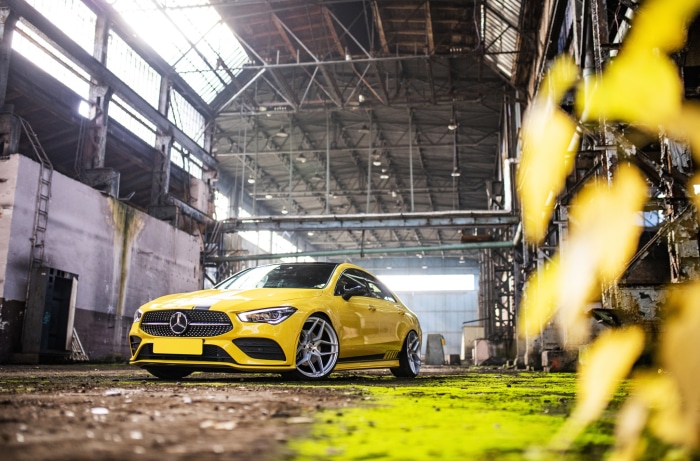 Yellow Mercedes-Benz CLA-Class in abandoned warehouse