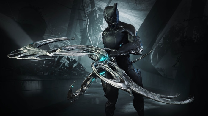 Warframe character holding a futuristic weapon