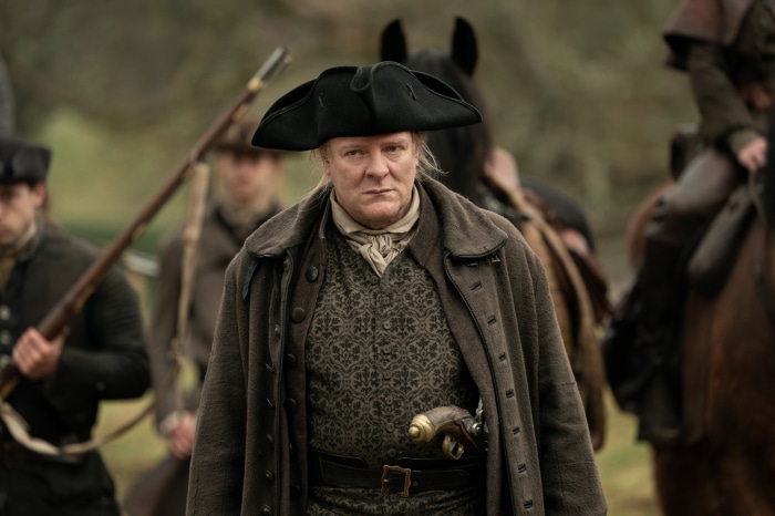 Man in historical attire with pistol from Outlander