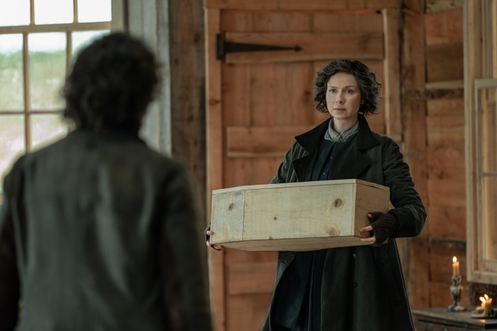 Claire Fraser from Outlander holding a wooden box