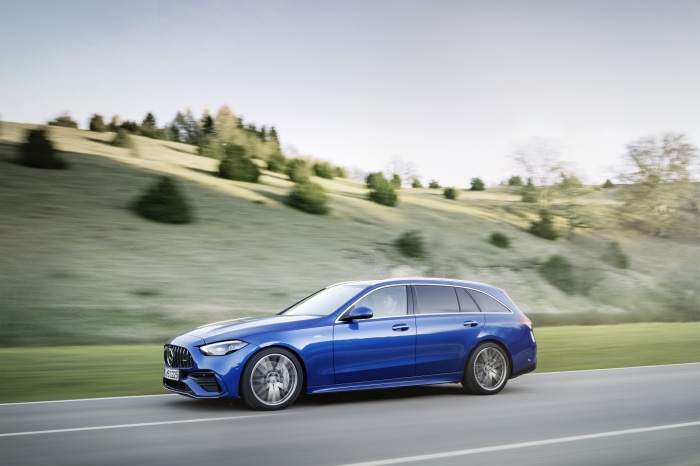 Blue Mercedes-AMG C 43 Estate driving on a road