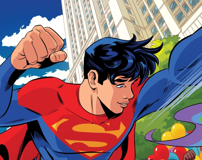 Jon Kent as Superman flying near buildings