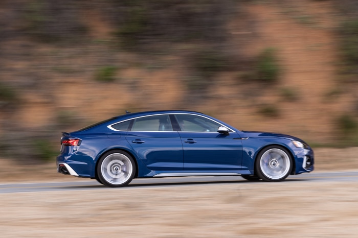 Blue Audi RS5 Sportback driving on a road