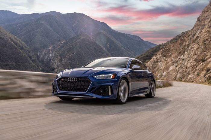 Blue Audi RS5 driving on a mountain road
