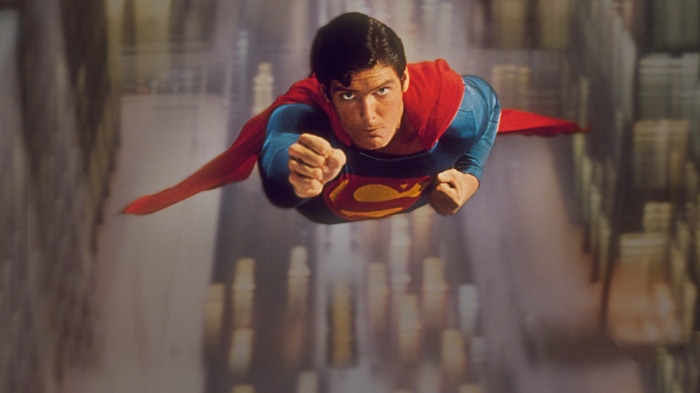 Superman flying over city