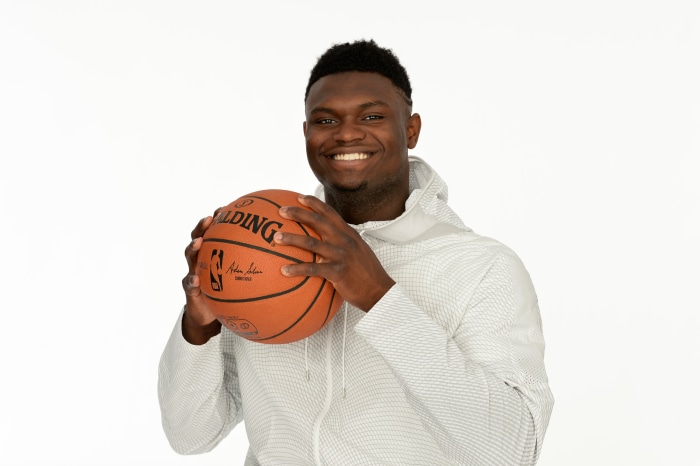 Zion Williamson holding a Spalding basketball