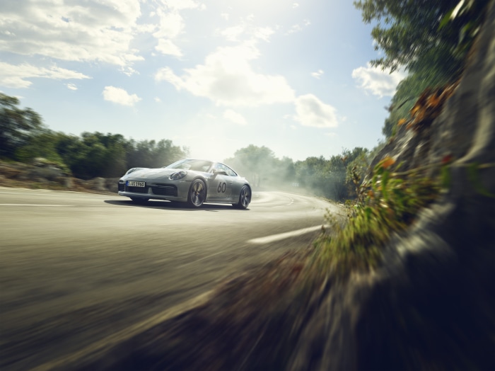 Porsche 911 driving on a winding road