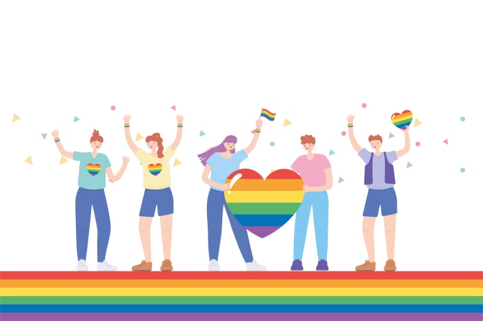 People celebrating LGBT pride with rainbow hearts and flags