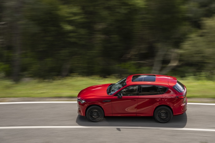 Red Mazda CX-60 driving on a road