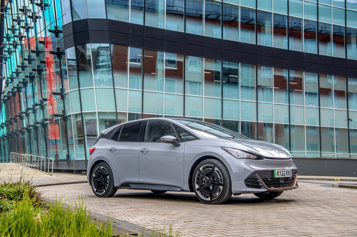 Cupra Born electric car parked in front of a modern building