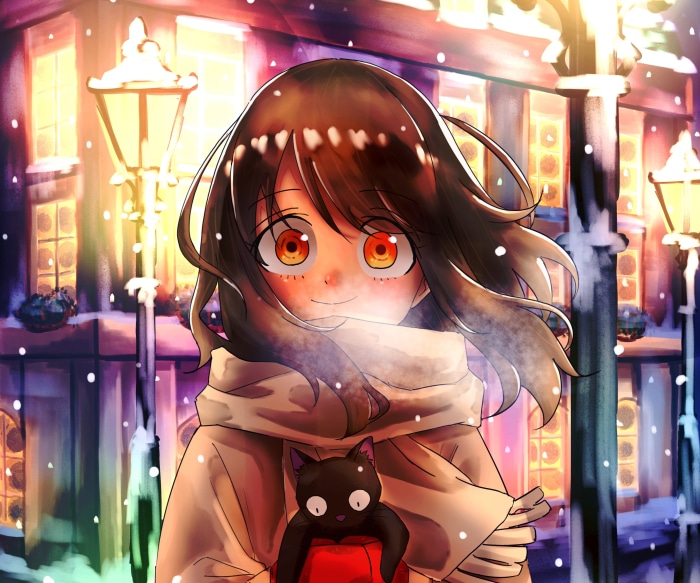 Girl holding a black cat in the snow