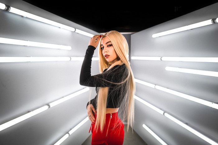 Ava Max in red skirt and black top