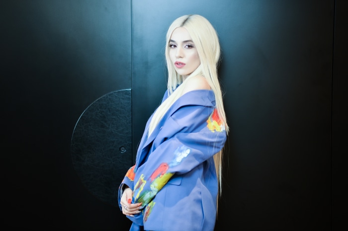 Ava Max in a blue blazer with painted designs