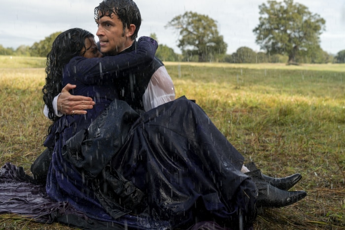 A man carrying a woman in the rain