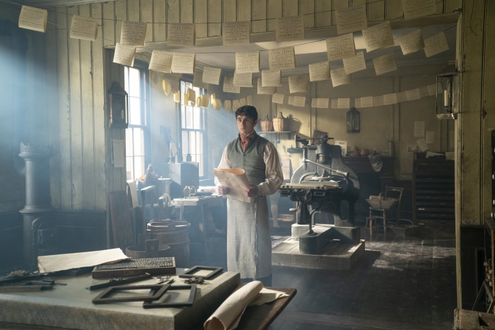 Man in a printing workshop from Bridgerton