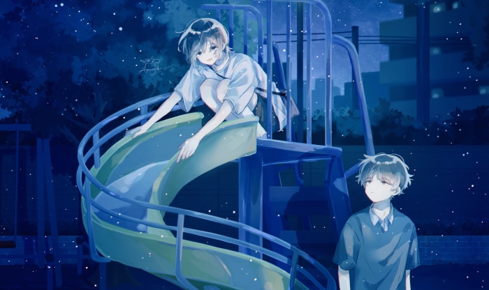 Couple on a playground slide at night