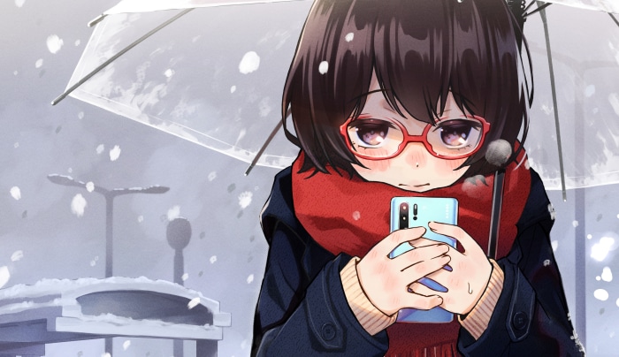 Girl with glasses holding a smartphone in the snow