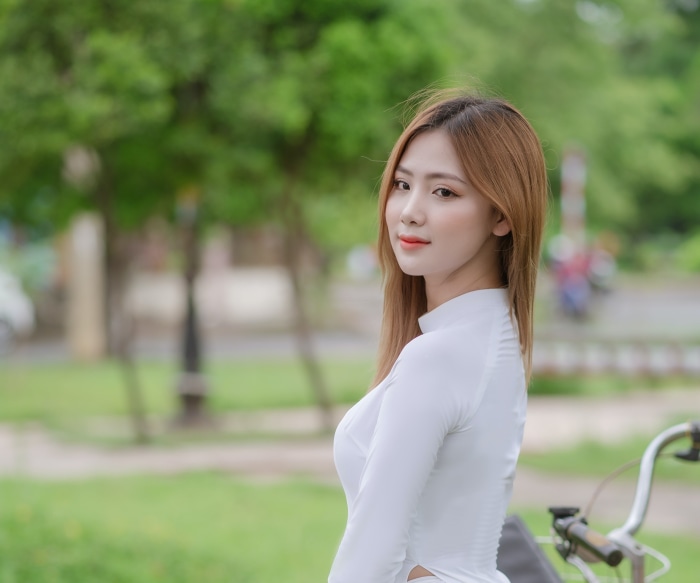 Asian woman in white dress outdoors