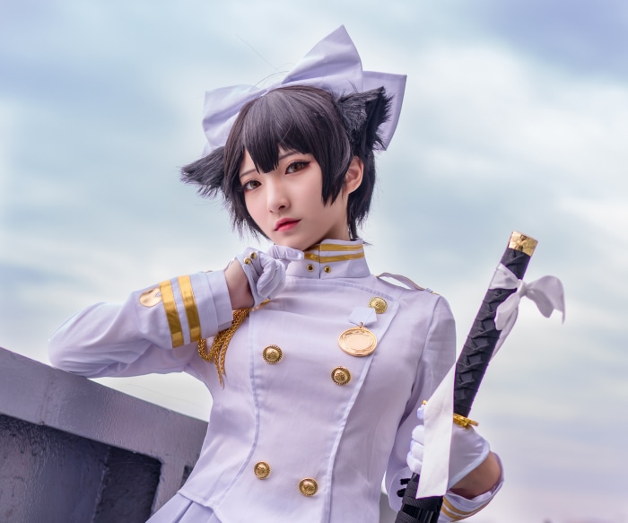Cosplay of a woman in a white uniform with cat ears