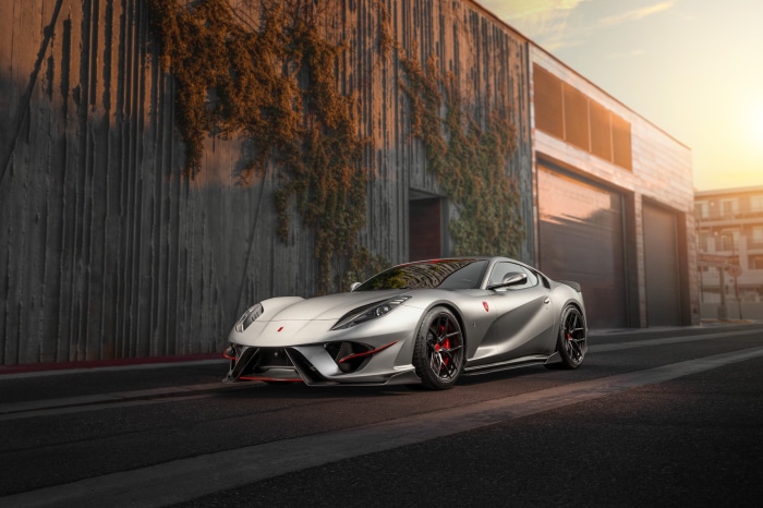 Silver Ferrari 812 Superfast parked outside a building
