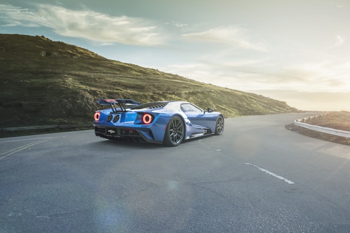 Blue Ford GT driving on a coastal road