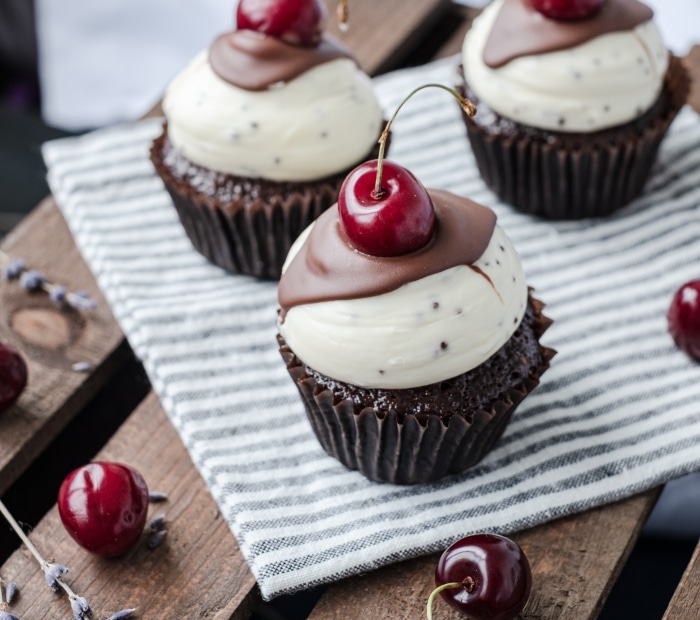 Chocolate cupcakes with white frosting and cherries 4K